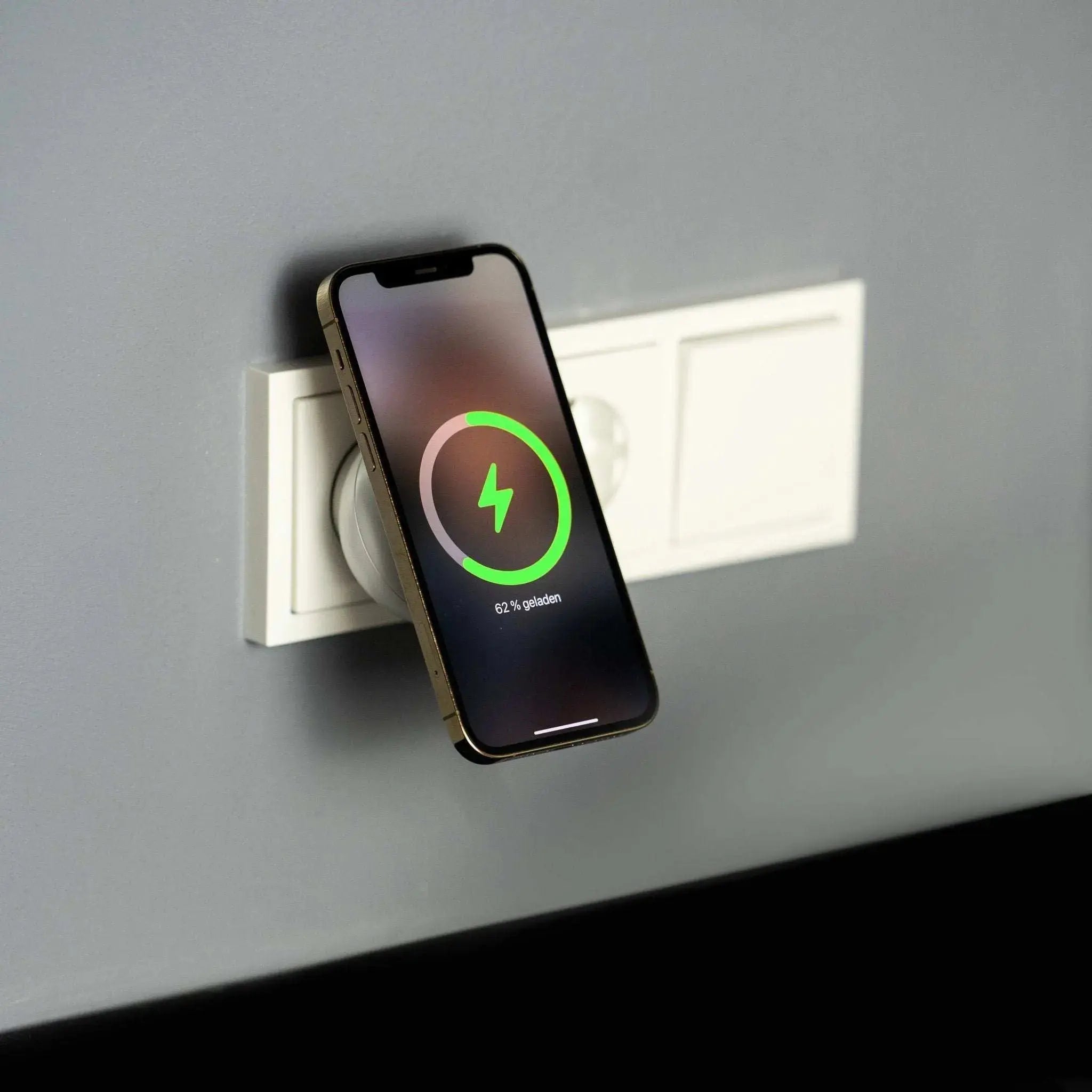 MAGnetic WallCharger wireless charging an iPhone attached to a wall socket
